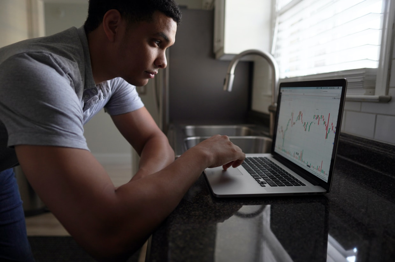 Man at desk looking at laptop display